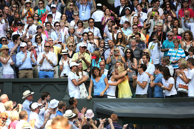 Marion Bartoli hugs her Fed Cup team mate Kiki Mladenovic after winning her first Slam at Wimbledon